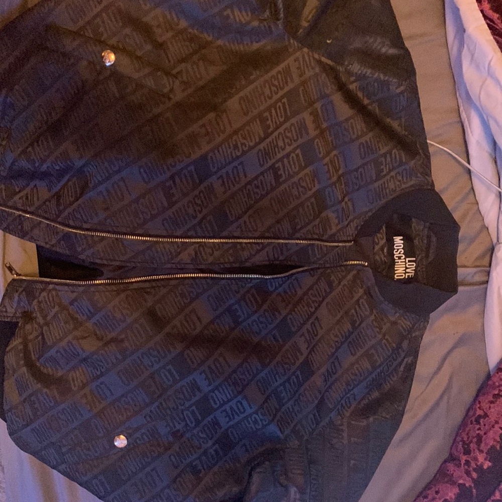 Selling a leather black polyester medium men’s black  zip up jacket